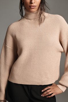 Has sweater weather ever looked (and felt) this good? The Good American Cozy Ribbed Turtleneck features a slightly oversized fit and a rolled turtleneck design, rendered in a plush knit fabric. | Cozy Ribbed Turtleneck Sweater by Good American in White, Women's, Size: Medium, Polyester/Nylon/Viscose at Anthropologie Beige Ribbed Turtleneck For Winter, Chic Winter Cropped Sweater With Funnel Neck, Oversized Textured Knit Turtleneck With Funnel Neck, Relaxed Fit Turtleneck For Winter, Beige Ribbed Turtleneck Outerwear, Winter Workwear Textured Knit Turtleneck, Oversized Textured Knit Long Sleeve Turtleneck, Oversized Textured Knit Turtleneck, Chic Knit Turtleneck With Ribbed Cuffs