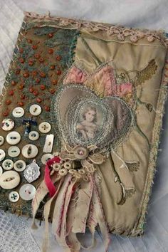 an old cloth box with buttons and other things on it, including a doll's head