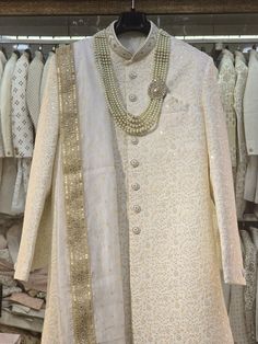 Make a grand statement on your special day with a luxurious Sherwani crafted from premium fabrics (like silk, brocade, or georgette) for ultimate comfort and sophistication. Our collection boasts a variety of designs to suit every taste: Classic elegance: Opt for a timeless Sherwani with intricate embroidery on the collar or cuffs. Modern flair: Go for a Sherwani with a unique neckline or a trendy color palette. Regal opulence: Choose a Sherwani with rich embellishments like zardozi work for a t Ivory Sherwani, Trendy Color Palette, Mens Wedding Suits, Zardozi Work, Sherwani For Men, Silk Brocade, Wedding Suits Men, Intricate Embroidery, Churidar