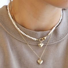 This necklace features a brass puff heart, gold-filled clasp, and freshwater pearls, all of which come together to form a beautiful and unique piece. Length: 16" Puffed Heart, Gold Heart Necklace, Freshwater Pearl Necklace, Freshwater Pearl Necklaces, Come Together, Heart Jewelry, Gold Filled Chain, Elevate Your Style, Heart Charm