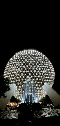 the spaceship shaped building is lit up at night