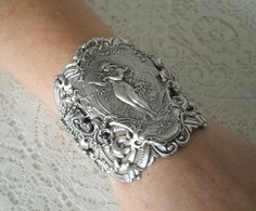 "This beautiful silver plated cuff bracelet has a silver plated art nouveau maiden, silver plated chain and lobster clasp. 2.75\" at the widest part. Adjustable." Antique Silver Elegant Wedding Bracelets, Elegant Antique Silver Bracelets For Wedding, Elegant Antique Silver Wedding Bracelets, Handmade Antique Silver Cuff Bracelet For Wedding, Victorian Antique Silver Bracelets For Wedding, Vintage Silver Decorative Jewelry, Elegant Antique Silver Cuff Bracelet, Vintage Decorative Silver Jewelry, Decorative Vintage Silver Jewelry