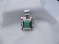 "This is a vintage sterling silver. 950 pendant. This square cut pendant is etched with some small open work pieces. I believe the square cut stone in the center is Jadeite. With bale this pendant is 1 & 1/2\" long & is stamped Mexico T6-182. Lovely stone center." Collectible Etched Rectangular Jewelry, Vintage Sterling Silver Square Pendant Jewelry, Vintage Sterling Silver Jewelry With Square Pendant, Collectible Sterling Silver Square Pendant Jewelry, Collectible Sterling Silver Jewelry With Square Pendant, Sterling Silver Square Pendant Jewelry For Collectors, Vintage Jewelry With Stamped 925 Rectangular Detail, Vintage Rectangular 925 Stamped Jewelry, Vintage Stamped 925 Rectangular Jewelry