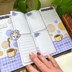 a woman's hand is holding an open planner book with coffee images on it