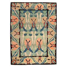 a rug with an abstract design on the front and back sides, in blue, pink, orange and yellow colors