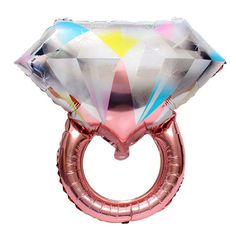 a pink and silver ring shaped balloon with an iridescent diamond on it's side