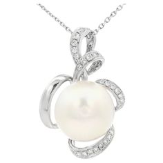 Embrace timeless elegance with this exquisite pendant, meticulously crafted in 18 Karat White Gold. At the heart of this design is a lustrous 13mm South Sea Pearl, renowned for its radiant luster and classic beauty. The pearl's pristine surface and natural glow make it a stunning centerpiece, symbolizing purity and sophistication. This luxurious pearl is gracefully entwined with a delicate swirl of 0.22-carat Diamonds, adding a touch of sparkle that enhances the pendant's overall allure. Each diamond is carefully set to catch the light, creating a mesmerizing effect that draws attention to its intricate design. The graceful curves of the gold setting add a modern twist to this classic piece, making it versatile for both everyday elegance and special occasions. This pendant is perfect for t Pearl Diamond Pendant, Sea Pearls, South Sea Pearls, Pearl Diamond, Natural Glow, Gold Set, Classic Beauty, Diamond Pendant, Pearl White