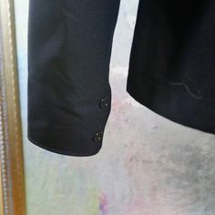 This Royal Navy dark blue wool sailor uniform shirt has, unsurprisingly, a wide Sailor collar, long sleeves with two navy buttons on the cuff, and a badge on the left upper arm with a crown above a stylized trident. The military Cracker Jacket naval shirt slips on, and is in excellent condition. Chest = 44 inches (111.76cm) (the extra space here allows a bit of room, but this is best fit for XL 42 US/UK) Shoulders = 19.5 inches (49.53cm) Sleeve Length = 27 inches (68.58cm) Shirt Length = 27 inch Business Peacoat With Button Cuffs And Long Sleeves, Business Peacoat With Button Cuffs, Wool Long Sleeve Tops With Button Cuffs, Long Sleeve Pea Coat For Work, Classic Long Sleeve Pea Coat With Button Cuffs, Black Long Sleeve Peacoat For Business, Black Long Sleeve Business Peacoat, Navy Pea Coat With Buttons For Work, Long Sleeve Wool Peacoat For Work