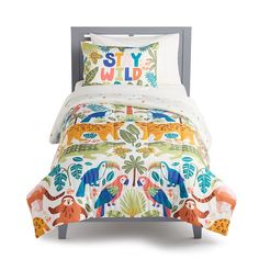 a bed with an animal themed comforter and pillow