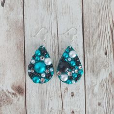 "These teardrop earrings are made with resin and glitter. They are then covered with faux pearls and glass rhinestones. The teal glitter base sparkles between the rhinestones and pearls. The pearls and rhinestones are hand placed individually. Their placement differs on each earring, making each one unique. Earring size (not including fish hook): 1.5 inches long The fish hook ear wires are made with a nickel free stainless steel. 925 sterling silver and gold tone ear wires are available as an up Teardrop Beaded Earrings For Party, Party Teardrop Beaded Earrings, Party Beaded Teardrop Drop Earrings, Party Beaded Teardrop Earrings, Teardrop Rhinestone Earrings For Gift, Gift Crystal Teardrop Earrings With Rhinestones, Crystal Teardrop Earrings With Rhinestones For Gift, Blue Rhinestone Drop Earrings, Turquoise And Black Earrings