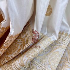 This exquisite handwoven banarasi silk saree in kora white with chand sitare motifs is nothing but enchanting. The floral border in golden zari combined with an elaborate zari woven pallu is nothing but regal. Approximate Length 6.5 mtrs (inclusive of blouse length)Height - 46 - 52" Saree comes with fall, picot and tassels done. Blouse piece is cut. Approximate weight - 650 gms Kindly Note : The colors you see on your device may vary due to the color reproduction, brightness and resolution of individual devices. If you'd like more clarity before your purchase, please contact our support team. Gold Elegant Dupatta With Traditional Patterns, Elegant Gold Dupatta With Traditional Patterns, Gold Saree With Traditional Patterns In Tissue Silk, Cream Dupatta With Motifs In Traditional Drape, Traditional Gold Saree With Traditional Patterns, White Silk Dupatta For Puja, Off White Tussar Silk Traditional Wear For Wedding, Gold Tussar Silk Saree With Traditional Patterns, Gold Banarasi Silk Dupatta With Traditional Patterns