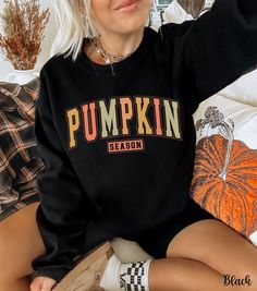 Embrace the cozy vibes of autumn with our Pumpkin Season Sweatshirt! This cute fall sweatshirt features "Pumpkin Season" emblazoned in fun fall colors, perfect for pumpkin patch outings or cozy days at home. Our pumpkin crewneck is crafted from soft, high-quality fabric that ensures warmth and comfort as the leaves change color. This adorable pumpkin sweater is a must-have addition to your autumn wardrobe, making it the ideal autumn sweatshirt for all your seasonal activities. Whether you're sea Fall Outfits With Sweatshirts, Fall Loungewear Sweatshirt, Fall Sweater With Letter Print And Long Sleeves, Long Sleeve Sweater With Letter Print For Fall, Black Fall Sweater For College, Cozy Letter Print Tops For Fall, Fall Letter Print Top For Loungewear, Letter Print Top For Fall Loungewear, Letter Print Lounge Tops For Fall