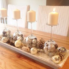 a wooden table topped with candles and ornaments