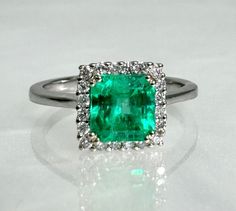 Square cut ring, emerald ring, emerald engagement ring, emerald ring for women, emerald diamond ring, 18k Emerald ring, 18K white gold ring A gorgeous emerald ring featuring a square step cut center stone weighing 1.24 carats surrounded by sparkling colorless diamonds set in solid 14k white gold. *Ring size: US 7 3/4 *Ring weight: 3.15 Grams *Center stone dimensions: 6.5mm Formal Green Emerald Ring With Halo Design, 14k White Gold Emerald-cut Emerald Ring For Wedding, 14k White Gold Emerald Cut Emerald Ring For Wedding, Formal Emerald Ring With Halo Setting, Brilliant Princess Cut Emerald Ring For May Birthstone, Green Diamond Platinum Ring With Prong Setting, Green Platinum Halo Ring With Center Stone, Emerald Ring With Halo Setting In Radiant Cut, Green Diamond Wedding Ring In 14k White Gold