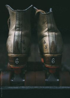 an old pair of shoes sitting on top of a skateboard with the number 6 written on it