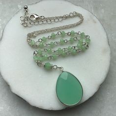 "A green natural stone Oval shaped pendant, in a Rhodium plated setting, suspended on a Rosary beading and silver plated chain, this necklace is great for day or evening wear. MATERIAL Silver Plated Chain - Nickle Free   Green rosary chain Green natural stone Pendant MEASUREMENTS Overall length incl chain extn 24\"/61cms Pendant length - 1.25\"/3cms PRESENTATION The Necklace will be attached to Giftcard, Giftwrapped in Tissue and tied with Ribbon, presented in a Organza Pouch - Perfect if you are sending direct as a Gift - I can also enclose a Message on your behalf, just message me the details. DELIVERY All Purchases are despatched 1st Class, Signed U.K Delivery - Tracked Worldwide with Royal Mail, to ensure a quick delivery. ESTIMATED DELIVERY TIMES U.K - 1 - 3 Days USA - CANADA - 5 - 10 Green Spiritual Beaded Chain Jewelry, Green Jade Beaded Chain Jewelry, Green Spiritual Jewelry With Beaded Chain, Jade Pendant Necklaces For Crafting, Spiritual Green Jewelry With Beaded Chain, Green Jade Jewelry With Beaded Chain, Green Beaded Pendant Necklace With Natural Stones, Green Pendant Beaded Necklace With Natural Stones, Green Gemstone Beads Pendant Necklace