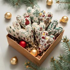 a wooden box filled with cookies next to christmas decorations