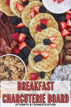 waffles, bacon, strawberries, and other breakfast foods are arranged on a platter