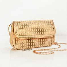 This small straw bag is a handmade evening clutch for women for any occasion: holiday, evening, wedding, going out. The natural straw bag will make you image complete. The mini shoulder purse is handmade using the technique of weaving on plastic canvas. It has a tight frame, keeps its shape well. SIZE: - SMALL - length 18cm/7 in, height 11cm/4 in, width 5.5cm/2 in - MEDIUM - length 23cm/9 in, height 14cm/5.5 in, width 6cm/2.3 in - LARGE - length 27cm/10.5 in, height 16.5cm/6.5 in, width 6.5cm/2.5 in DETAILS: - thread is 100% raffia - removable chain handle: 118cm/46 in - color - beige - 100% silk lining (sewn by an invisible stitch manually) with inside pocket - magnetic button - item comes in a packing bag. NOTE! The lining pattern and chain pattern may differ from photo. Washing instruct Elegant Straw Shoulder Bag, Chic Gold Straw Bag, Rectangular Straw Shoulder Bag For Evening, Elegant Straw Beach Bag, Elegant Straw Crossbody Bag For Daily Use, Chic Rectangular Straw Clutch, Elegant Crossbody Straw Bag For Daily Use, Beige Straw Evening Bag, Elegant Natural Straw Crossbody Bag