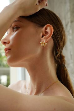 Evoke the essence of spring with the Magnolia Floral Stud Earrings, blooming with timeless elegance. Delicate magnolia blossoms crafted in intricate detail cradle lustrous pearls, creating a captivating floral motif. These earrings are the perfect accessory to elevate any outfit, whether it's a romantic date night or a casual brunch with friends. Pair them with a floral sundress and sandals for a fresh and feminine look, or with a tailored blazer and trousers for a sophisticated touch to your wo Feminine Blossom Jewelry For Spring, Elegant Flower Jewelry For Spring, Elegant Spring Flower Jewelry, Elegant Wedding Earrings For Spring, Elegant Spring Wedding Earrings, Dainty Spring Flower Earrings For Wedding, Dainty Flower Earrings For Spring Wedding, Feminine Jewelry With Matching Earrings For Spring, Dainty Spring Wedding Flower Earrings