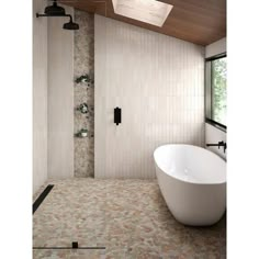 a bath tub sitting next to a shower in a bathroom under a skylight on top of a tiled floor