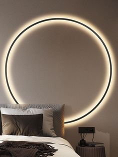 a bedroom with a circular light above the bed