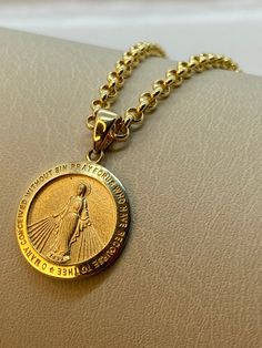 "14k Gold virgin Mary with rolo chain , 4.41 gr , 20\"inches ,2mm. please text me if you like to make the chain  shorter or longer , its possible ! Premium spring ring for added safety! Priced to sell! Compare our prices to other similar sellers! Arrives in a GIFT BOX and includes FREE SHIPPING within the USA and Canada. International shipping is available at the most economical rates on ETSY. I HAVE BEEN IN THE JEWELRY BUSINESS ALL MY LIFE. I am a second -generation family member making gold and jewelry. Please feel free to ask me any questions - Always happy to help! Fast Replies to messages! Superior Quality and Best Prices!" Gold Miraculous Medal Necklace Gift, Gold Round Pendant With Miraculous Medal, Gold Miraculous Medal Round Pendant Jewelry, Yellow Gold Necklace With Miraculous Medal Round Pendant, Yellow Gold Necklace With Miraculous Medal, Yellow Gold Miraculous Medal As Gift, Gold Jewelry With Miraculous Medal For Memorial, Gold Charm Necklaces For Commemoration, 14k Gold Necklace With Miraculous Medal For Anniversary