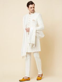 This Royal White Embroidered sherwani will instantly give an elegant look. Made from polyester cotton fabric, this 3 piece sherwani set features a white royal sherwani, front buttons fastening, designer cuff buttons, pocket square, and a mandarin collar. This white base sherwani has beautiful subtle gold Jaal thread-sequin embroidery work all over. It is paired with white churidar pants and matching dupatta. An ideal outfit for traditional & special events.

Size Chart For Men





	
	
					Men' Embroidered Off White Cotton Sherwani, Embroidered Off-white Cotton Sherwani, Designer Cotton White Nehru Jacket, Designer White Cotton Nehru Jacket, White Cotton Nehru Jacket For Designer Wear, Designer Embroidered Cotton Sherwani, Designer White Nehru Jacket, White Sherwani With Naqshi Embroidery, White Cotton Nehru Jacket With Zari Work