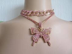 Jewellery set- Iced Out Butterfly necklace set-Statement- Cuban Links Chain Choker-gold plated chain-covered in pink Cubic Zirconia crystals-adjustable to fit Necklace- gold plated and covered with pink Cubic Zirconia crystals- Pendant-gold plated butterfly covered in pink CZ crystals See my shop https://www.Merlinscaveshop.com for more beautiful items. Pink Cubic Zirconia Rhinestone Necklace As Gift, Gold Crystal Rhinestone Necklace For Valentine's Day, Valentine's Day Gold Crystal Rhinestone Necklace, Valentine's Day Gold Rhinestone Jewelry, Pink Clavicle Chain Jewelry For Wedding, Pink Cubic Zirconia Clavicle Necklace, Pink Rhinestone Jeweled Necklace For Parties, Pink Cubic Zirconia Pendant Necklace, Costume Jewelry Sets With Rhinestones For Gifts