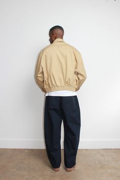 - Hidden front zipper closure Two side pockets Elastic waistband Beige Windbreaker For Work With Pockets, Beige Workwear Windbreaker With Pockets, Workwear Beige Windbreaker With Pockets, Beige Half-zip Casual Outerwear, Relaxed Fit Half-zip Outerwear With Pockets, Casual Beige Half-zip Outerwear, Beige Track Jacket With Pockets For Streetwear, Half-zip Cotton Outerwear With Pockets, Urban Half-zip Outerwear With Pockets