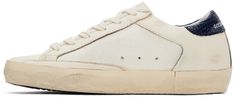 Handcrafted low-top canvas and buffed leather sneakers in off-white. · Smudging throughout · Lace-up closure · Logo perforated at tongue · Padded collar · Glittered signature star at outer side · Logo stamp at outer side · Logo stamp at snake-embossed heel tab · Suede, buffed leather, and terrycloth lining · Treaded rubber sole Available exclusively at SSENSE. Supplier color: Navy/Brown Golden Goose Deluxe Brand, Navy And Brown, Star Sneakers, Super Star, Logo Stamp, Golden Goose, Terry Cloth, Leather Sneakers, Low Top