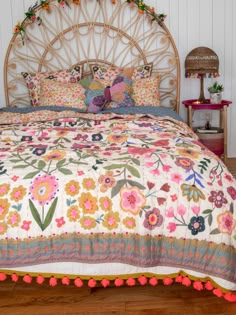 the bed is made with colorful flowers on it