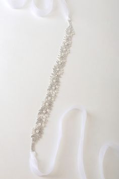 The Lulus Sweetest Ending Silver Rhinestone and Pearl Bridal Belt is the perfect touch for your special day! Look absolutely gorgeous with this belt that features sparkling, clear glass rhinestones (in silver settings) along with shiny faux pearls that shape an abstract design. Sheer ribbons tie together at the back for an elegant finish. 88" Long. Embellishment Measures 16" Long And 1" Wide . 50% Glass, 35% Copper, 10% Pearl, 5% Nylon. Imported. Lulus | Sweetest Ending Silver Rhinestone and Pea Mariana Hardwick, Untamed Petals, Bridal Halo, Bridal Hairdo, Veil Headpiece, Wedding Sash Belt, Wedding Vision Board, Gold Belts, Vancouver Wedding