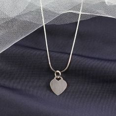 Personalized Heart Pendant Necklace The heart tag measures 17mm x 14mm, and it is made of sterling silver. The pendant is a great size for engraving initials. When you buy the pendant for yourself, you might want to have your own initials engraved but when you are buying it as a gift, you can have the initials of the recipient engraved on the tag instead.  This heart pendant is a nice gift for parents to give to their daughters, and it looks great with most silver chains that she might already have. It is small enough that it will not look too large on a smaller frame, and it will look great with many of the little outfits that she already has. She will love when you engrave her initials on it, and she can show it to her friends proudly. The heart tag pendant is something that she will be Memorial Silver Heart Charm Necklace, Nickel Free Silver Heart Pendant Charm Necklace, Nickel-free Silver Heart Pendant Charm Necklace, Sterling Silver Heart Pendant Necklace With Charms, Nickel-free Minimalist Sterling Silver Heart Necklace, Minimalist Silver Heart Necklace, Silver Heart Charm Necklace For Memorial, Nickel Free Heart Shaped Sterling Silver Charm Necklace, Nickel-free Double Heart Sterling Silver Charm Necklace