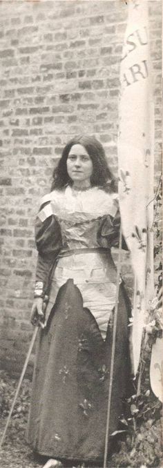 an old black and white photo of a woman dressed in medieval clothing with skis