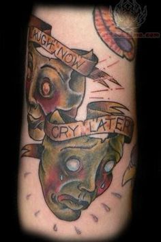 a tattoo on the arm of a man with a demon head and banner around his neck