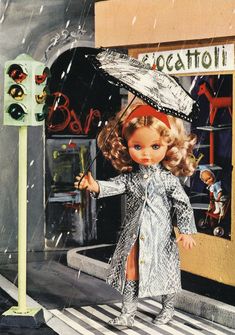 a doll is holding an umbrella while standing on the street in front of a store