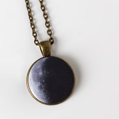 "Ever wonder what the moon looked like on your birthday? Or the birth dates of your children? The day you got married? Or the date of a person you love who passed on? This is a larger and more traditional version of our beloved birth moon necklace. Available in antique bronze or shiny silver tone, this 1 inch pendant hangs on an 18\" chain and makes a great gift. To order, please provide the following information in the \"message to seller\" at checkout: Date (in this format: MM/DD/YYYY), Time Z Circle Moon Charm Necklace For Gift, Moon Print Moon-shaped Necklace Gift, Black Round Jewelry For Birthday Gift, Moon Print Moon Shaped Necklace Gift, Moon Print Moon Shaped Necklace For Gift, Moon Shaped Necklace With Moon Print For Gift, Moon Print Necklace Perfect For Gifts, Sun And Moon Design Circle Jewelry For Gift, Sun And Moon Design Round Pendant Necklace For Gift