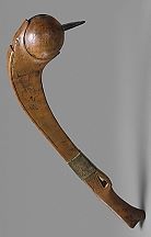 an old wooden hook with a long handle on it's end, in the shape of a snail