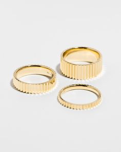 three gold rings sitting next to each other