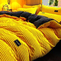 a bed covered in yellow and black comforters