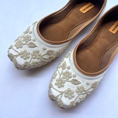 Pearl White Floral Summer Bridal Ballet Flat Shoes - Handcrafted Elegance with Indian Flair Step into timeless elegance with our Pearl White Bridal Ballet Flat Shoes, meticulously handcrafted with a touch of ethnic Indian charm. Perfect for brides, bridesmaids, or anyone seeking both style and comfort for weddings or special occasions. Each pair is adorned with delicate beadwork in pearl white, exuding understated sophistication and grace. The ballet flat design ensures all-day comfort, allowing Traditional Wedding Shoes With Embroidery And Round Toe, Wedding Flats With Zari Work And Round Toe, Festive Wedding Shoes With Embroidered Round Toe, Festive Embroidered Wedding Shoes With Round Toe, Closed Toe Wedding Shoes With Dori Work, Wedding Shoes With Dori Work And Closed Toe, Wedding Flats With Gota Work, Flat Wedding Shoes With Handwork For Reception, Elegant Wedding Shoes With Dori Work