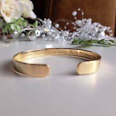 "Don't settle for ordinary gifts when you can create something extraordinary. Our engraved bracelets are the epitome of personalization, allowing you to celebrate birthdays in a truly unforgettable way. - 22K gold plated bracelet  - Your engraving outside or inside the cuff  - Up to 90 characters on each side - Approximately 8mm wide  SIZES: This is the length of the metal, not including the opening between the ends. The bracelets are adjustable. 4\" (baby/toddler size) 5\" (child size) 6\" (sta Anniversary Bracelet With Engraved Text, Engraved Jewelry For Birthday Gift, Engraved Bracelets For Anniversary And Father's Day, Spiritual Engraved Bracelets For Anniversary, Classic Engraved Bangle For Gifts, Gold Engraved Wristband For Gift, Gold Wristband Gift, Adjustable Gold Bracelet With Engraving Option For Gift, Father's Day Gift Name Bracelet With Engraved Text