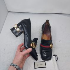 Gucci Black Gg Peyton Pearl Leather Heel Shoe Size Eu 38 Us 8 Womens Comes With Dustbag 100% Authentic The Double G Antique Gold-Toned Hardware Is Set On A Blue And Red Web Of These Leather Heels. The Stacked Heel Has A Row Of Gg Pearls And Studs And The Back Is Designed To Be Worn With The Heel Folded Down Or Up. Black Leather With Blue And Red Web Double G Gg Pearl And Studs Square Toe 3.25" Heel Please Note Signs Of Wear And Refurbished On Bottom As Shown. Please Note Staining On Footbed As Shown. Please Note Any Lines Or Scratches Have Been Polished Over As Shown. Please Note The Gg That Is On The Pearl Embellishment In The Back On One Shoe Is Missing, Not Noticeable From Afar Gucci Heels With Gold-tone Hardware For Evening, Gucci Heels With Gold-tone Hardware For Formal Occasions, Gucci Evening Heels With Gold-tone Hardware, Gucci Formal Heels With Gold-tone Hardware, Luxury Gucci Heels With Gold-tone Hardware, Gucci Black Square Toe Heels, Designer Calf Leather Heels With Gold-tone Hardware, Leather Heels With Horsebit Detail For Office, Designer Heels With Gold-tone Hardware For Work