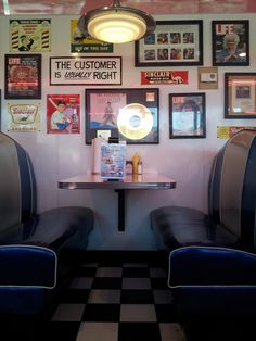 two blue chairs sitting in front of a table