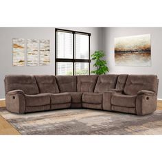 a large sectional couch with two recliners in front of a painting on the wall