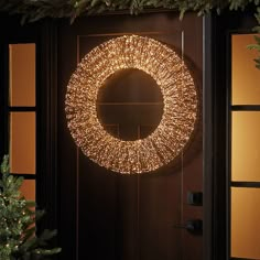 a lighted wreath on the front door of a house