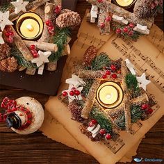 christmas decorations are arranged on top of sheet music and lit candles in the shape of snowmen