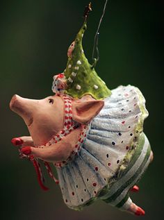 a small toy pig hanging from a string