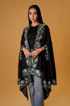 "Complement your outfit with this Royal Velvet Cape. This is a very easy to style cape and it can be paired with any top, blouse, dress, or any other thing, no doubt you'll stand out from the crowd. Product Details Condition Brand New Velvet Cape with Floral Kashmir Aari Embroidery. Colour: Black Size: 82\" X 35\" (208.28 cms X 88.9 cms) approx. One Size Fits All If you want a bigger or smaller size (dimensions), we can make it for you on order, just drop us a message. Care Instructions - Dry Cl Shawl Cape Outfit, Festive Cape-shaped Dupatta With Resham Embroidery, Festive Cape Dupatta With Zari Work, Festive Cape Dupatta With Resham Embroidery, Festive Cape Shape Dupatta With Resham Embroidery, Festive Resham Embroidery Cape Dupatta, Black Embroidered Shawl For Wedding, Traditional Cape-style Dupatta For Festive Occasions, Traditional Festive Dupatta With Cape Shape